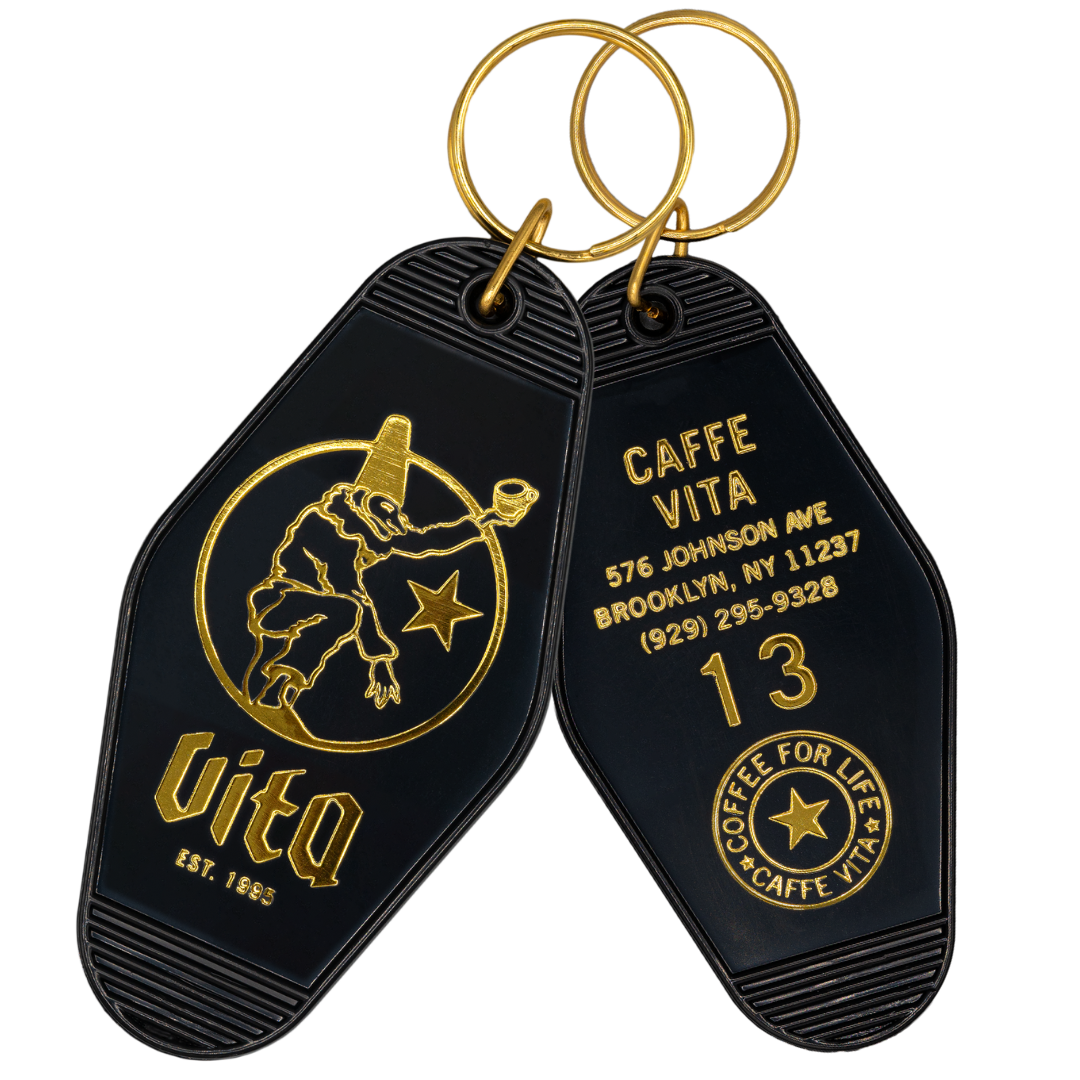 Fron and back of keychain. Gold print with Vita logo on one side and NYC address + emblem on other side. 