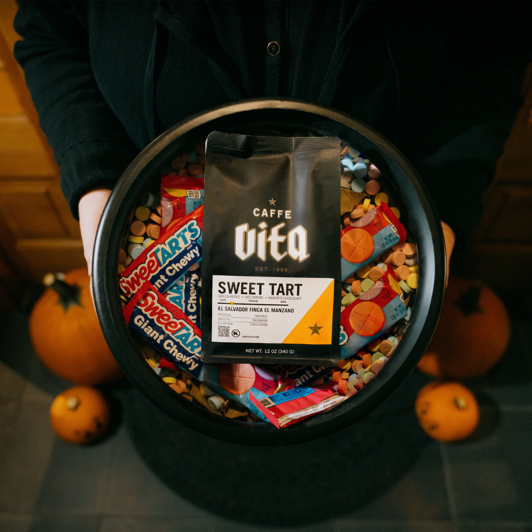 12oz bag of Sweet Tart in cauldron full of candy next to pumpkins. 