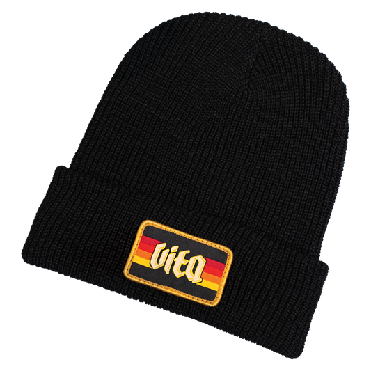 Sunset beanie front with logo patch, no background.